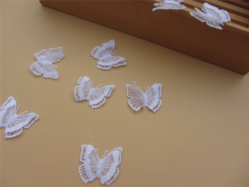 May include: White lace butterfly appliques, perfect for adding a delicate touch to crafts, clothing, or home decor.