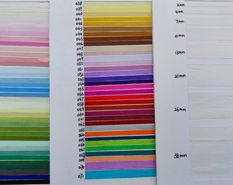 May include: A color chart with 71 different colored fabric samples. The samples are arranged in rows and columns. The fabric samples are labeled with numbers from 038 to 071. The chart also includes a column with different widths of fabric, labeled in millimeters: 2mm, 4mm, 7mm, 10mm, 13mm, 20mm, 26mm, and 38mm.