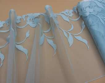 May include: Light blue lace trim with a floral design. The lace is delicate and has a soft, flowing texture.