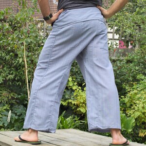 May include: A pair of light blue striped pants with a wide leg and a drawstring waist.