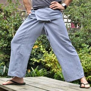 May include: A pair of light blue striped pants with a wrap-around style. The pants are made of a soft, comfortable fabric and have a relaxed fit.