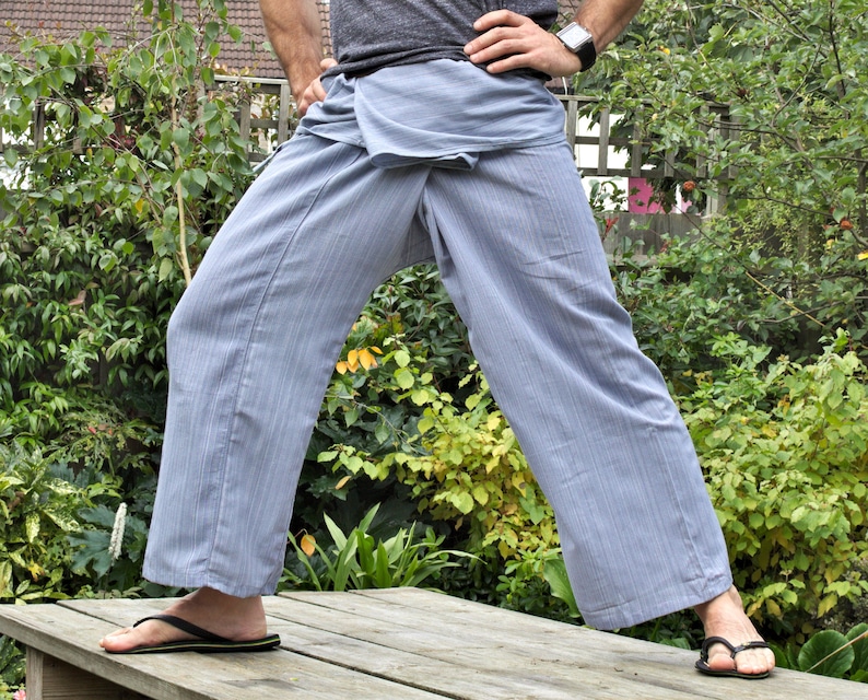May include: A pair of light blue striped pants with a wrap-around style. The pants are made of a soft, comfortable fabric and have a relaxed fit.