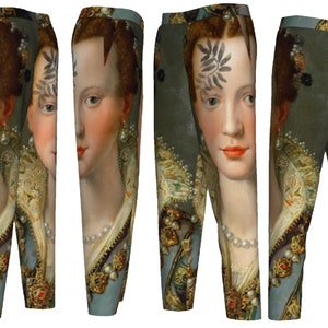 May include: A pair of blue, green, and gold pants with a portrait of a woman on the fabric. The woman has a pearl necklace and a floral design on her forehead.