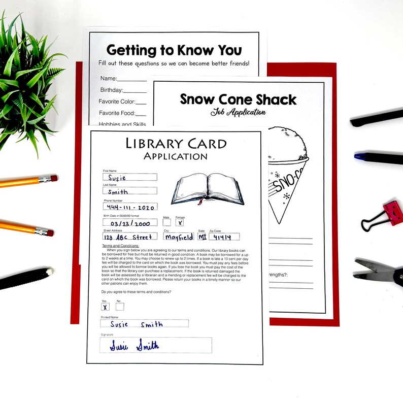 May include: Three printed paper forms including a Library Card Application with filled-in fields for Susie Smith, a Getting to Know You questionnaire, and a Snow Cone Shack job application featuring a graphic of a snow cone in a paper cup.