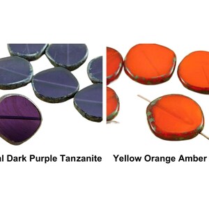 May include: Two sets of round, flat, gemstone beads. The first set is dark purple with a slight sheen. The second set is bright orange with a slight green tint. The text below the beads reads "Crystal Dark Purple Tanzanite" and "Yellow Orange Amber Opal".