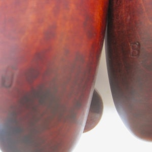 Puede incluir: Dos estiradores de zapatos de madera con un acabado marr&oacute;n. Los estiradores de zapatos tienen una letra "B" estampada en ellos.