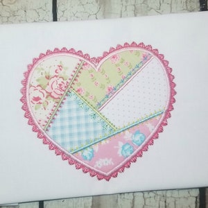 May include: A pink heart-shaped patch with a patchwork design. The patch is made of different fabrics with floral, checkered, and polka dot patterns. The heart is outlined with a pink scalloped edge.