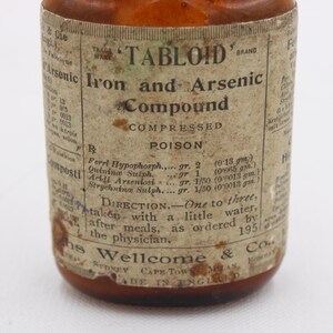 May include: An antique brown glass bottle with a label that reads "TABLOID Iron and Arsenic Compound." The label includes the word "POISON" and directions for use. The bottle is from 1951.