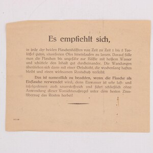 May include: A vintage, tan-colored paper with German text. The text is in a serif font and appears to be instructions or a guide. The paper is slightly aged, with a few small imperfections.
