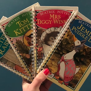 May include: Four Beatrix Potter children's books with colourful covers and illustrations. The books are titled "Peter Rabbit", "Tom Kitten", "Mrs Tiggy-Winkle", and "Jemima Puddle-Duck".