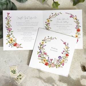 Image shows a wildflower wedding invitation with guest information printed to the inside and back and delicate, pretty watercolour paintings of wildflowers and grasses.