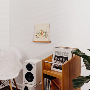 record ledge for one record to display your records on a floating shelf. angel Olsen phases, ficus fiddle leaf fig, white speakers, album art display