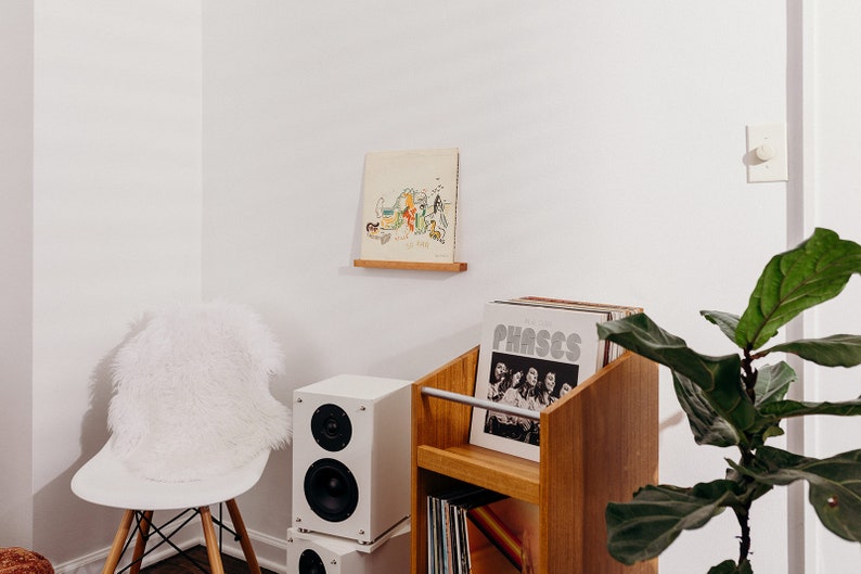 record ledge for one record to display your records on a floating shelf. angel Olsen phases, ficus fiddle leaf fig, white speakers, album art display