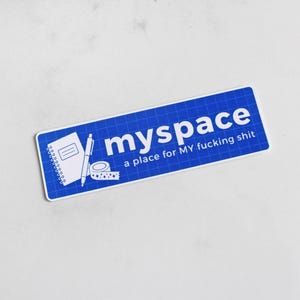 May include: A rectangular blue sticker with a white grid pattern. It features a white line drawing of a spiral notebook, a pen, and a roll of tape. The text reads "myspace" in large letters and "a place for MY fucking shit" in smaller text.