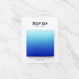 May include: A pack of blue gradient sticky notes with the text "Deep Sea Sticky Notes" and "Muze Lab" on the front.