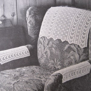 Könnte beinhalten: Gecrochetete Überzüge für die Rückenlehne und Armlehnen eines Sessels in Weiß. Der Sessel ist mit einem floralen Muster bezogen.