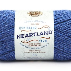 May include: A skein of Lion Brand Heartland yarn in the color Blue Heather. The yarn is a medium weight acrylic and is suitable for hand-crafts. The label reads "EST. 1875- LION BRAND HEARTLAND YARN -HAND-CRAFTS- ARTISANAT -SENSATIONALLY SOFT SENSATION DOUCE- PREMIUM ACRYLIC ACRYLUIQUE DE QUALITE SUPERIEURE LIONBRAND.COM"