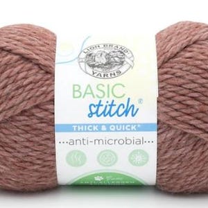 May include: A ball of Lion Brand Basic Stitch Thick & Quick yarn in the color "Dusty Rose". The label reads "Basic Stitch Thick & Quick...anti-microbial..."