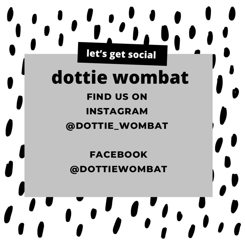 May include: A graphic with a white background and black abstract shapes. A grey rectangle contains the text "dottie wombat", "Find us on Instagram @dottie_wombat", and "Facebook @dottiewombat". A black banner reads "let's get social".
