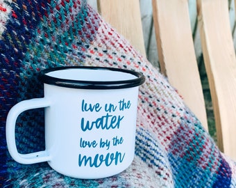 White enamel mug, live in the water, live by the moon mermaid life Camping wild swimming beach life Blue writing.Cute Travel mug with slogan