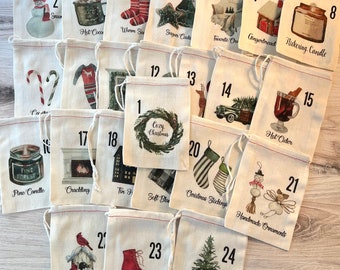May include: A collection of twenty-four small off-white fabric drawstring bags, each numbered from 1 to 24. Every bag features a unique watercolor illustration of holiday-themed items like snowmen, candles, stockings, and trees with text labels.