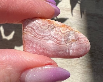 Lovely Rhodochrosite tumble with deep pink saturation and beautiful banding