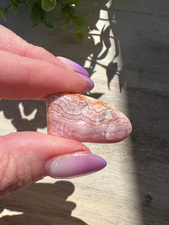 Rhodochrosite tumble with deep pink saturation and beautiful banding from Argentina manganesespar tumble grade A