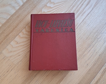 May include: A red hardcover book with the title "Vacu-Lavesu Varnica" printed in gold lettering.