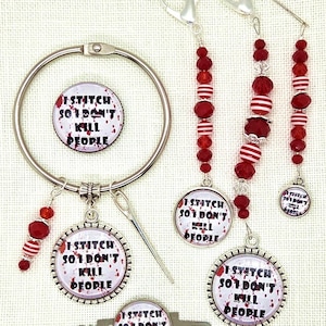 May include: A collection of knitting accessories, including stitch markers, a ring, and a needle. The stitch markers and charms feature a red and white design with the text "I STITCH SO I DON'T KILL PEOPLE."
