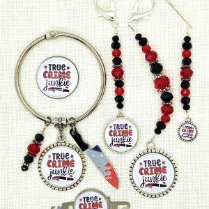 May include: A collection of true crime themed accessories. Includes a binder ring, charms, and a knife charm. The charms have the text "TRUE CRIME junkie" with a knife graphic. Red and black beads are used in the design.