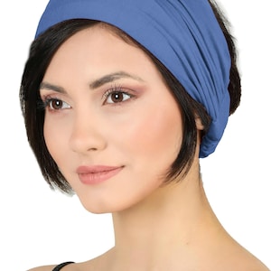 May include: A blue headband made of soft fabric. The headband is wrapped around the head. The colour is a muted blue, and the fabric appears to be stretchy and comfortable. This accessory is suitable for various hairstyles.