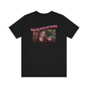 May include: Black t-shirt with a pink graphic of a woman with curly hair and the text "Rolling with the homies" repeated twice.