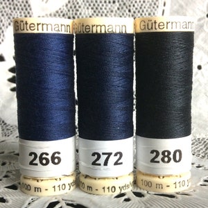 May include: Three spools of Gütermann thread in shades of navy and black. The spools are labeled with the numbers 266, 272, and 280. Each spool contains 100 meters or 110 yards of thread.