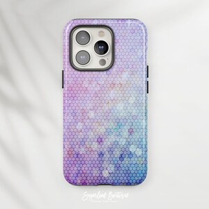 May include: A purple and blue phone case with a honeycomb pattern. The case has a cutout for the camera lens.