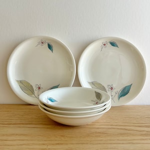 May include: Set of three white ceramic plates with a floral design in shades of green and pink. The plates have a simple, elegant design and are perfect for everyday use.