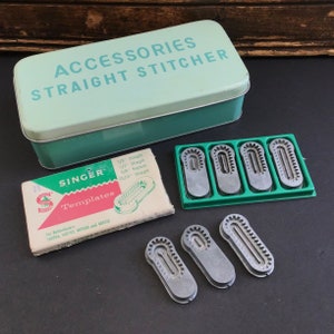 May include: A mint green metal box labelled "ACCESSORIES STRAIGHT STITCHER" is next to a Singer Templates box and several metal sewing machine attachments. The attachments are in a green tray and loose.