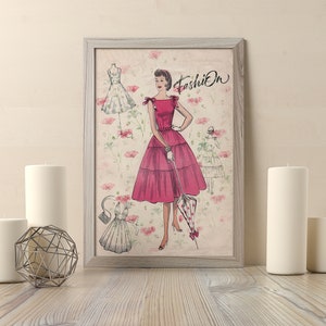 May include: A framed vintage illustration of a woman wearing a pink dress with a white collar and a white glove. The woman is holding a pink and white umbrella. The illustration is surrounded by a floral pattern and the word "Fashion" is written in the top right corner.