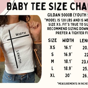 May include: White baby tee size chart with measurements in inches. The chart includes sizes XS to XL, with width measurements from 16.1" to 20" and lengths from 20.5" to 26.4". The text also mentions the shirt is Gildan 5000B.