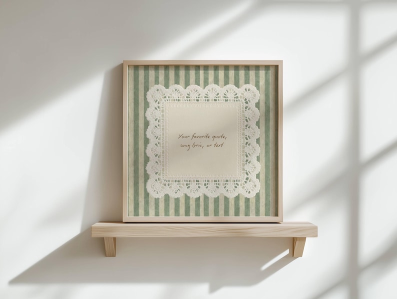 May include: A framed artwork featuring a white lace doily on a green and white striped background. The frame is light brown. The text on the doily reads: "Your favorite quotes, song lyrics, or text."