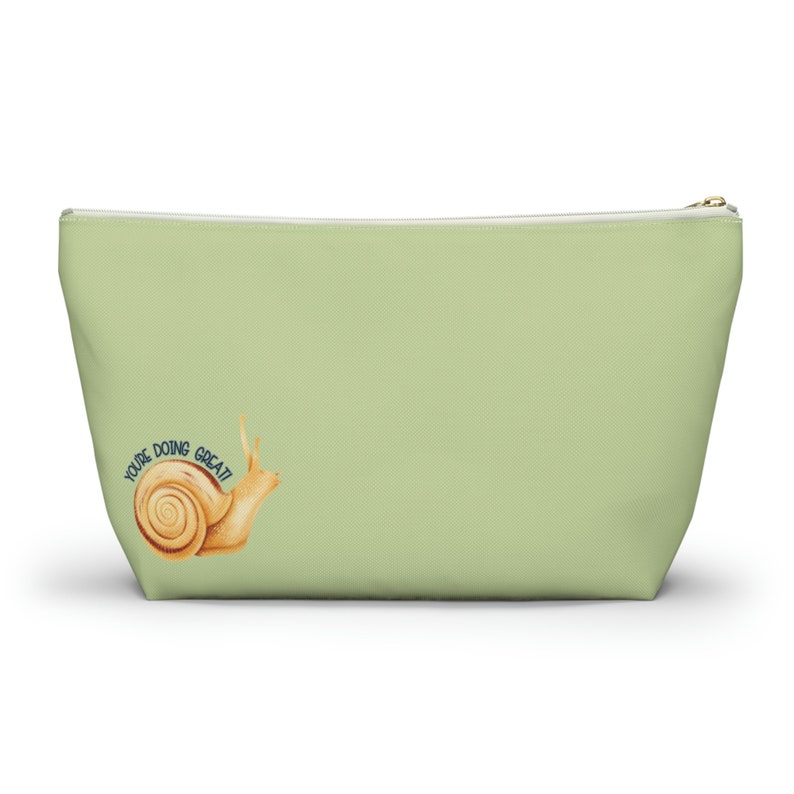 T-bottom pouch in moss green with a mushroom and the words Gorgeous Goblin Gear on the front and a cute snail with a positive message of You're doing great! on the back. Black zipper