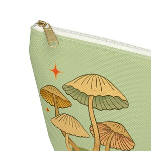 T-bottom pouch in moss green with a mushroom and the words Gorgeous Goblin Gear on the front and a cute snail with a positive message of You're doing great! on the back. Black zipper