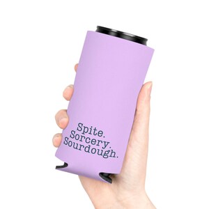 Can cooler featuring a dark serif font design that reads “Spite. Sorcery. Sourdough.” printed on a purple background.