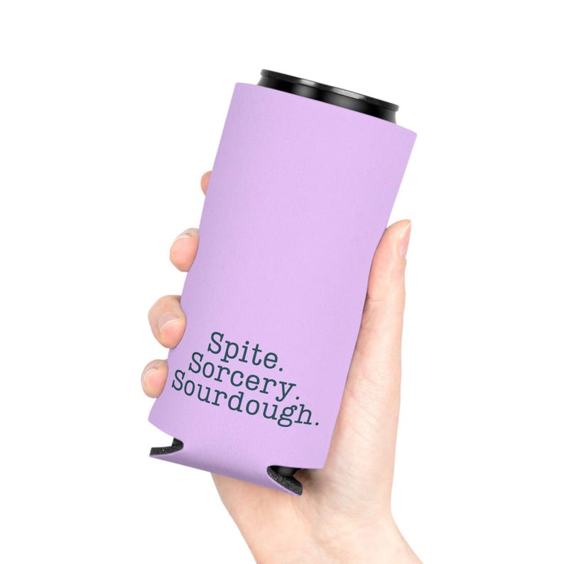 Can cooler featuring a dark serif font design that reads “Spite. Sorcery. Sourdough.” printed on a purple background.