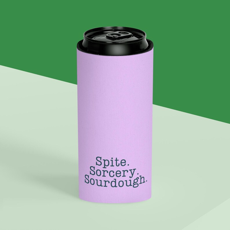 Can cooler featuring a dark serif font design that reads “Spite. Sorcery. Sourdough.” printed on a purple background.