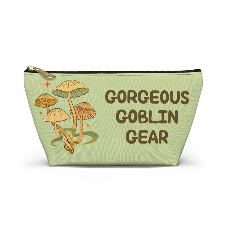 T-bottom pouch in moss green with a mushroom and the words Gorgeous Goblin Gear on the front and a cute snail with a positive message of You're doing great! on the back. White zipper