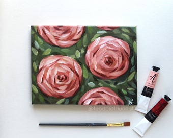 Pode incluir: Uma pintura de rosas cor-de-rosa sobre um fundo verde. A pintura está em tela e é emoldurada. A pintura é assinada pelo artista.