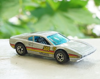 1982 Vintage HOT WHEELS Ferrari Racebait 308 Turbo SIlver Car with Red and Yellow Detail. Made by Mattel, Inc.