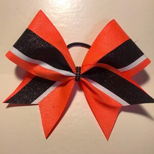 Cheer Bow Neon orange black and white- All glitter with rhinestone center Cheer Bows by Blingitoncheerbowz Can do in ANY Colors