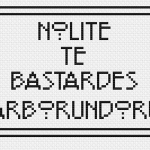 May include: Black and white cross-stitch design with a decorative border. The text reads "Nolite Te Bastardes Carborundum".