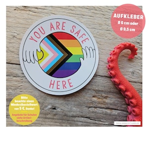 May include: A circular sticker featuring the text YOU ARE SAFE HERE in pink letters. The center displays a progress pride flag design held by two white line-art hands. The sticker is available in diameters of 6 cm or 9.5 cm as indicated by text.